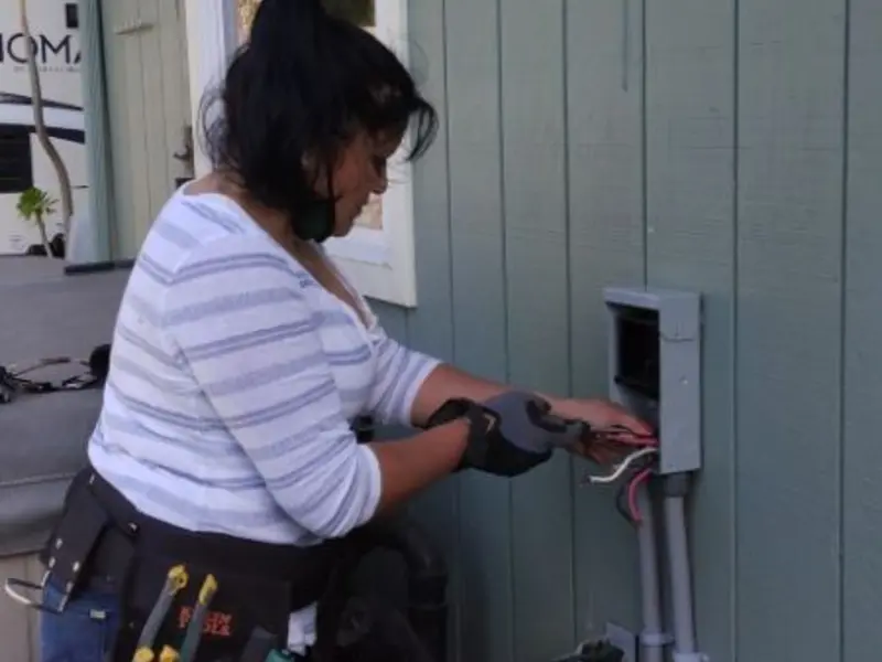 Licensed electrician wiring an exterior subpanel in Eastham
